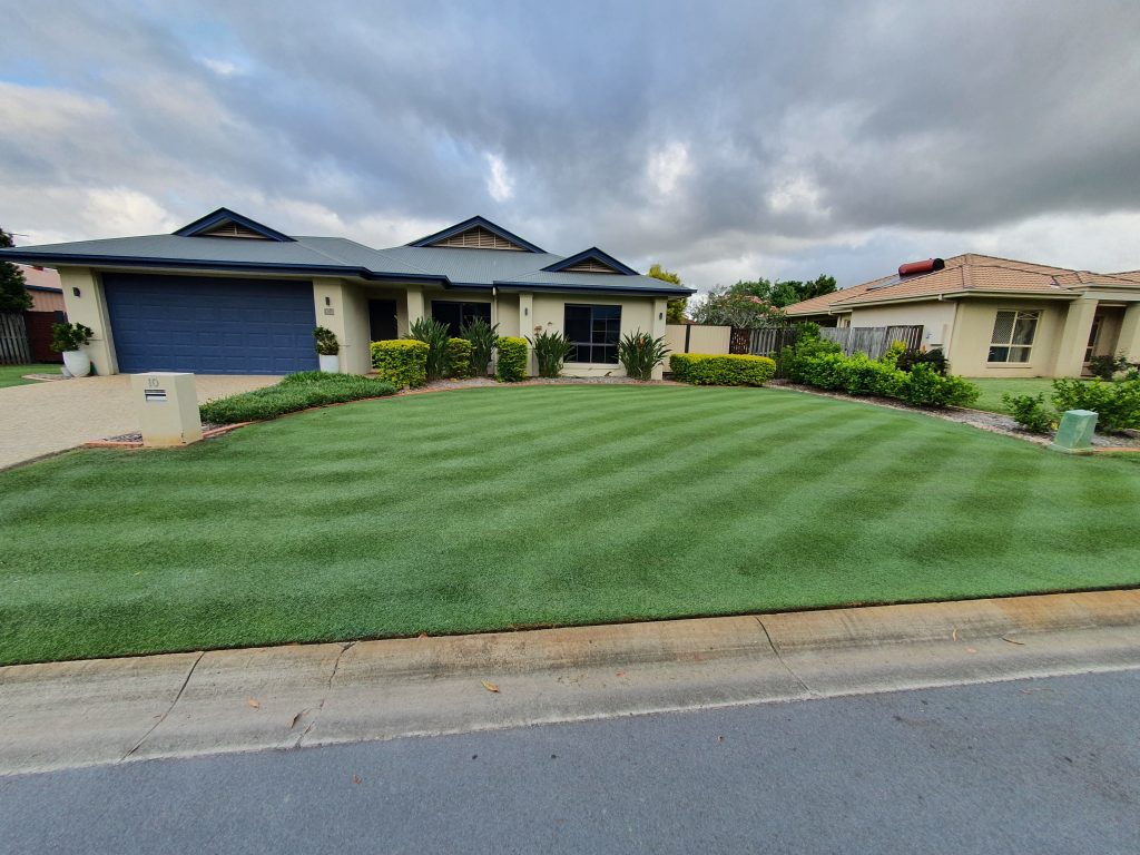 View of the front of a house with the lawn cut in a checkered pattern | featured image for Rodney - Narangba.